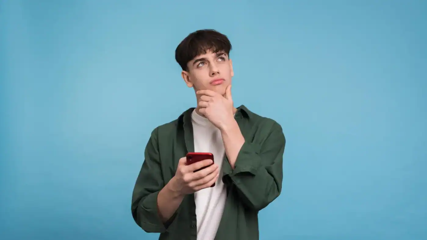 Person comparing CBD oil vs gummies options while researching wellness products online