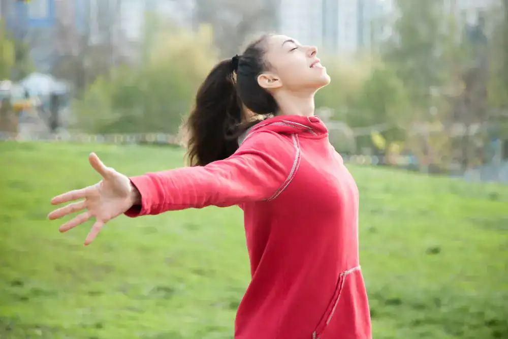 Woman feeling relief after choosing between CBD oil vs gummies for wellness support
