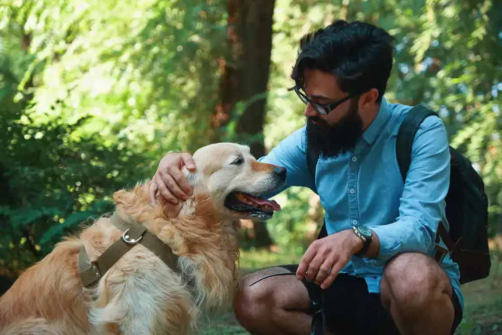 a handsome man with his dog in beautiful greenery outdoor