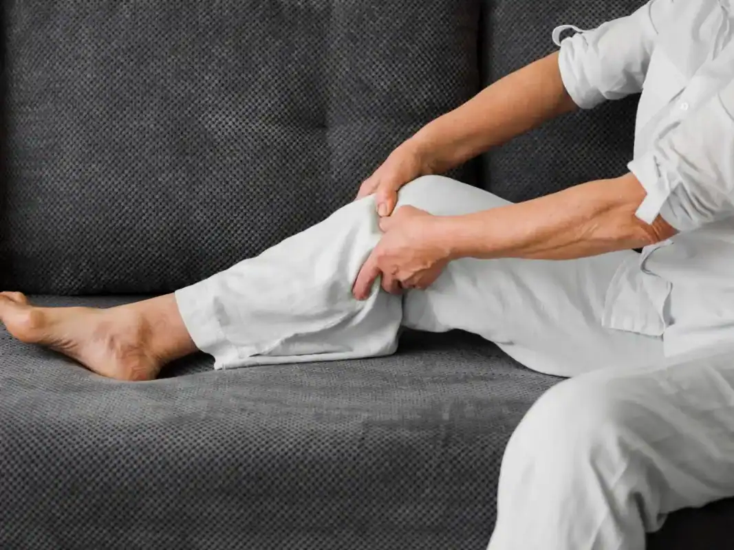 restless leg  male sitting on sofa